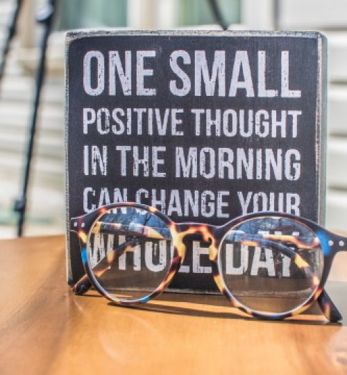 photo-of-a-sign-and-eyeglasses-on-table-1485657